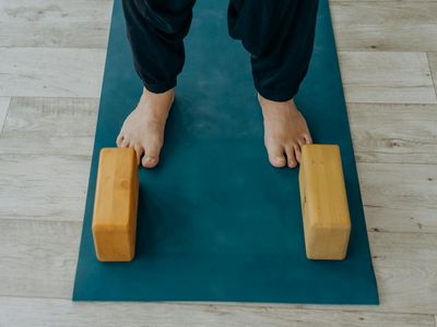 Simple wooden yoga blocks arranged neatly on the floor.